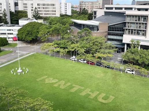 Green lawn at National Tsing Hua University with the NTHU lettering mown into the grass